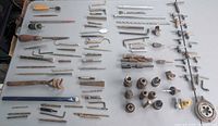 Full layout of approximately 100 assorted tools on table