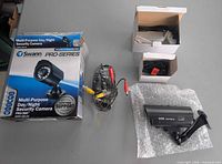 Camera, cable, adapter, and box laid out