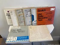 Eight tape boxes displayed, showing Scotch 250 branded and hand-labeled cartons