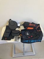 Assorted bags, pouches, cable, case and mount laid out on table