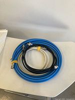 Three coiled cables—blue outer, white middle, black inner—showing BNC connectors