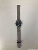 Front view of titanium wristwatch with mesh bracelet