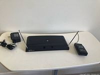 Front view of Boss WS-20 receiver with antennas, WS-20T transmitter, and power adapter