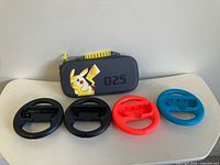 Front view of Pikachu carrying case with four Joy-Con wheels