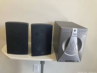 Front view of two Advent bookshelf speakers and Coby subwoofer