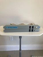 Front view of the two grey Hammond rack power strips stacked on table