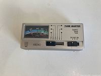 Front view showing analog meter, controls, Seiko branding