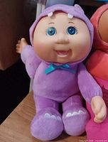 Purple dinosaur-costume doll close-up