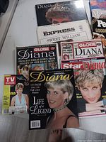 Group shot showing multiple Princess Diana magazines, calendar and newspaper