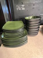 Stack of plates and bowls showing quantity, shape, and colors