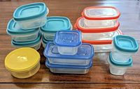 Front angled view of all 14 containers stacked by lid color