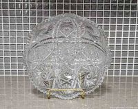 Front view of cut glass bowl showing geometric patterns and sawtooth rim