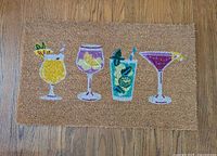 Top view of entire coir doormat with four cocktail glass design