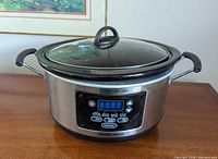 Front view of stainless steel Hamilton Beach digital slow cooker showing control panel and lid