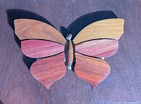 Front view of wooden intarsia butterfly showing grain and color