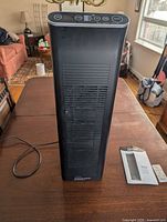 Full view of Ionic Pro Platinum TA750 air purifier with remote and manual on table