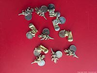 Group of 11 metal animal coin holders, each with penny