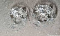 Top view of both clear pressed glass bowls showing starburst pattern