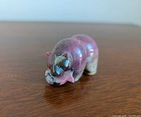 Front/side view of rhodonite bear figurine holding fish