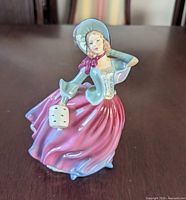 Front view of Royal Doulton Autumn Breeze figurine showing colors and design
