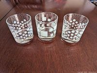 Front view of three matching Pasabahce lowball glasses showing etched white polka dot and square patterns
