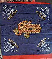 Full view of blue Calgary Stampede bandana with Bell logos