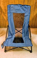 Blue folding beach chair unfolded front view