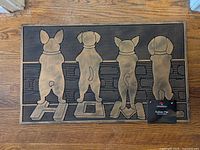 Front view of doormat showing dog silhouettes and HOME text