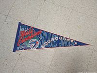 Front view of blue felt pennant showing graphics and text