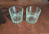 Pair of clear fluted glass tumblers on table