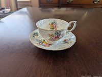 Teacup on saucer showcasing pattern and gold trim