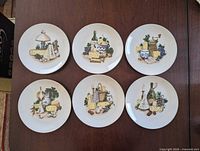 front view showing all six illustrated plates on tabletop