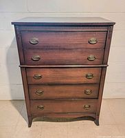 Front view showing five drawers, brass pulls, overall design