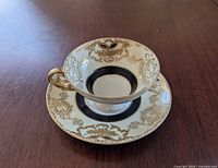 Teacup on saucer showing decoration