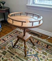 Full view of table showing spindle rail, turned pedestal, tripod legs