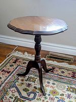 Full view of wooden pedestal table on rug