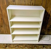 Front view of white bookcase showing four shelves