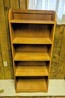 Front view of light wood five-shelf bookcase