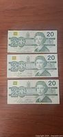 Obverse view of three Canadian $20 Birds of Canada series notes