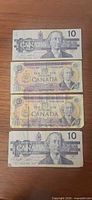 Fronts of four Canadian $10 banknotes