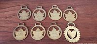 All eight brass harness medallions front view