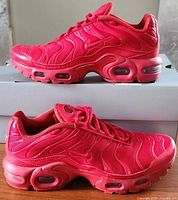 Side profile of both shoes showing exterior lateral view, visible air units, clean uppers.