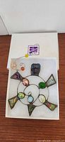 Top view of stained glass turtle sun catcher in box