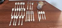 Flat lay of all flatware and jug on table