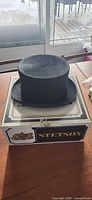 Front view of black top hat on Stetson box