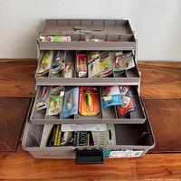 Flambeau tackle box open showing trays with packaged lures