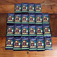 All 22 sealed Unfinity draft booster packs arranged on table