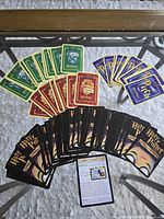 Spread of card backs and a sample character card illustrating variety