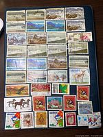 Album page of assorted Canadian used stamps, multiple themes and denominations