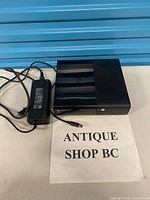 Top and front view of Xbox 360 E console with power supply brick